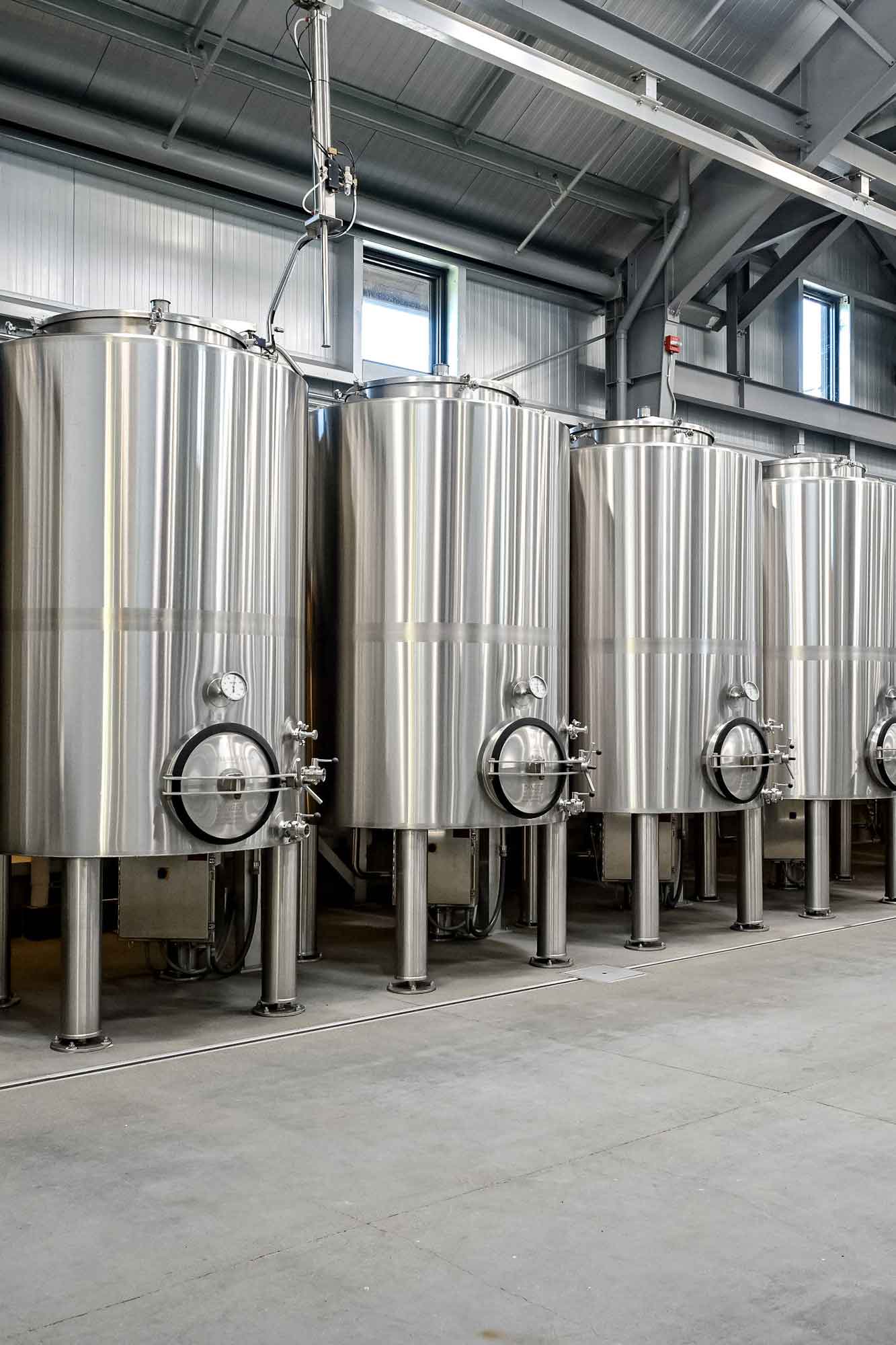 row of winery tanks in a cellar